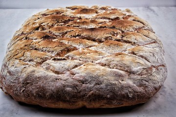 Sourdough bread with crispy crust on shelf. Bakery goods
