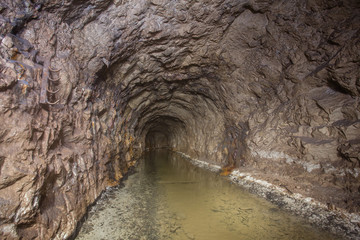 Underground abandoned bauxite ore mine tunnel with water