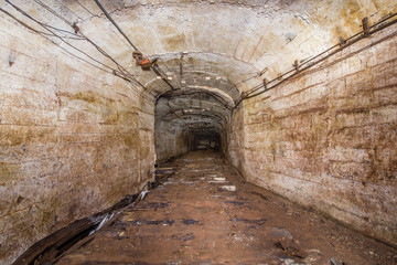 Fototapeta na wymiar Underground abandoned bauxite ore mine tunnel with concrete lining