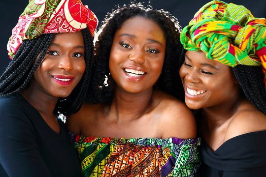 african models wearing traditional headdress posing for the camera