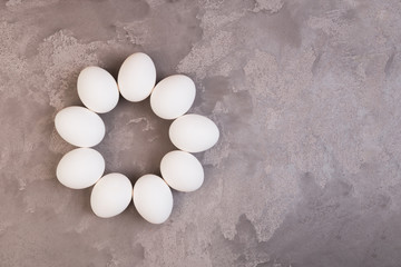 White Easter eggs on grey marble table. Copy space.