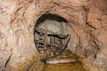 Underground bauxite mine tunnel with collapsed toilet shithouse