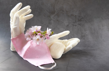 A pair of medical gloves, mask, soap