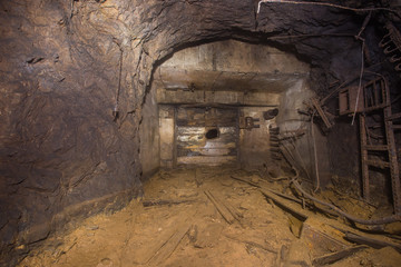 Fototapeta na wymiar Underground abandoned bauxite ore mine tunnel with broken wall