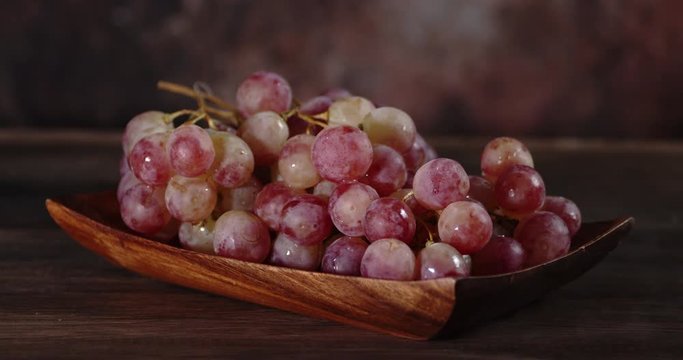 Bunch of grapes on a plate with cool steam.
