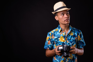 Portrait of young handsome Indian tourist man