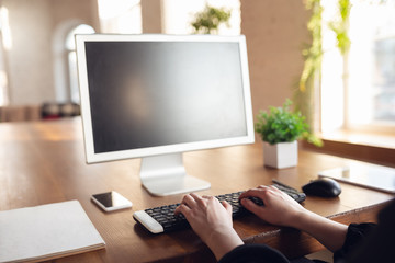 Typing text, close up. Caucasian young woman in business attire working in office. Young businesswoman, manager doing tasks with smartphone, laptop, tablet has online conference. Finance, job.