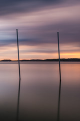 Pair of poles in sea during long exposure