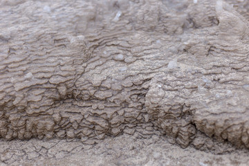Close up shot of ice shards and weird frozen sand shapes on cold beach