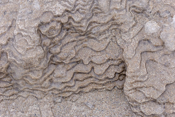 Close up overhead shot of frozen sand that appears to be a moonscape or planet landscape in outer...