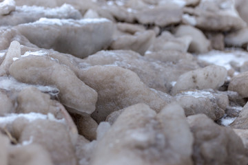 Obraz na płótnie Canvas Close up shot of small frozen blocks of sand on a beach on a very cold day