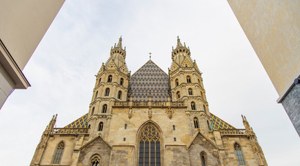 Fototapeta na wymiar Europe medieval architecture cathedral facade gorgeous building urban view from below in concrete building walls symmetry frame in vienna capital of Austria, travel life style site