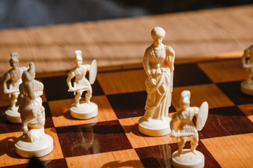 Chess white and black pieces fight on the battlefield for their king