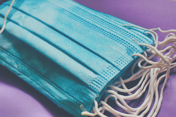 close-up of a pack of surgery face mask on a purple background