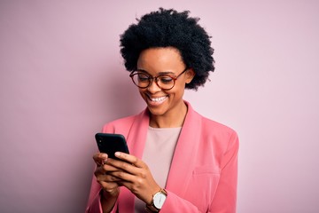 Young African American afro woman with curly hair having conversation using smartphone with a happy...