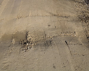 Gravel road, frost heave and dip at center line culvert
