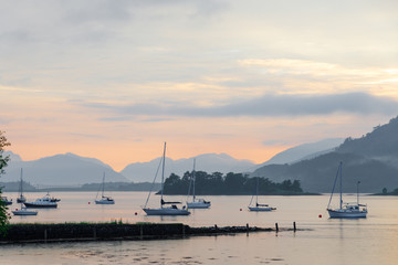 Fototapeta na wymiar Beautiful sunset at Loch Leven at Glencoe at low tide with sailing boats