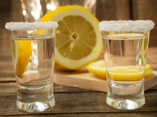 Glass with tequila and lemon and salt