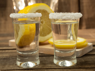 Tequila, salt and lemon on a wooden background