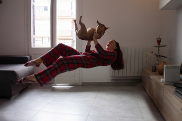Happy young woman levitation with dog
