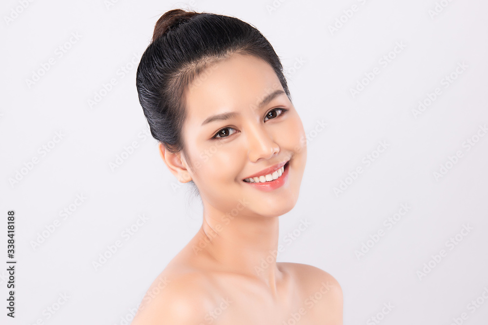 Wall mural Beautiful Young Asian Woman with Clean Fresh Skin. Face care, Facial treatment, Cosmetology, beauty and healthy skin and cosmetic concept, woman beauty skin isolated on white background