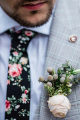groom with a bright tie and a flower on a jacket, closeup