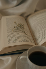 Obraz premium old book with coffee and dry flowers