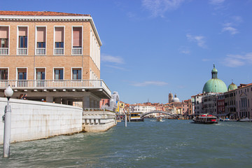 Various public and private water transport moving along the river canal in Venice city, Italy.