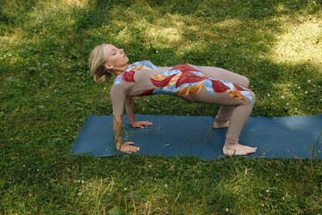Healthy life exercise concept - Woman doing Hatha yoga asana ardha purvottanasana (Reverse Table Pose). plank pose outdoors