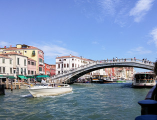 Tourists swim by river canal taxi and explore the local sights in Venice city in Italy.