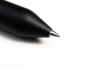 A macro shot of the writing tip with a portion of the barrel of a streamlined modern black...