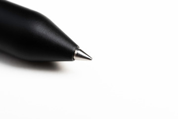 A macro shot of the writing tip with a portion of the barrel of a streamlined modern black...
