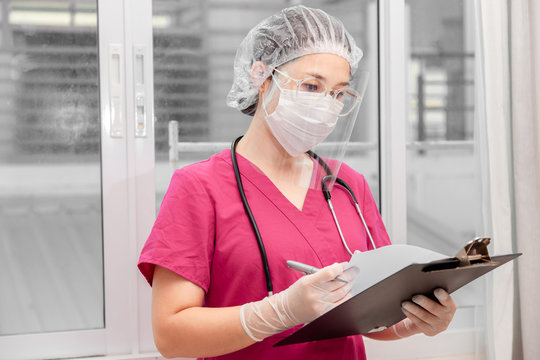 Doctor Medical Checking Information Consulting Patient For Outbreak COVID-19 Epidemic Virus Outbreak Concept . Medical Staff In Face Shield And Medical Mask For Prevention Of Coronavirus Pandemic .