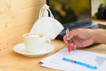 Work from home with hot coffee on the table / hot coffee with laptop on work space 