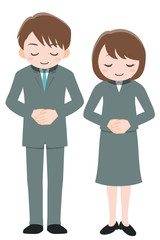 お辞儀をしているスーツ姿の男女