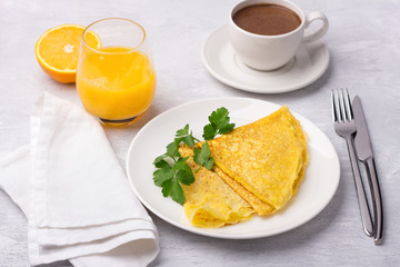 Keto breakfast high-fat low-carb, pancakes without flour and nuts, ketocoffee (bulletproof) with coconut oil, freshly squeezed orange juice and orange on a light gray background