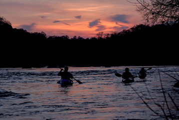 Paddlers on River at Sunset