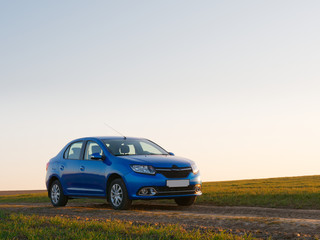 Belarus blue car in a field in spring at sunrise - 338426372