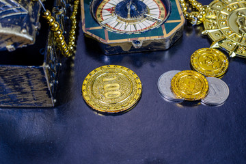 pirate medal chest and compass on a black background