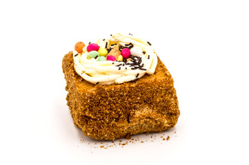 Square of chocolate brownie decorated with creamy
