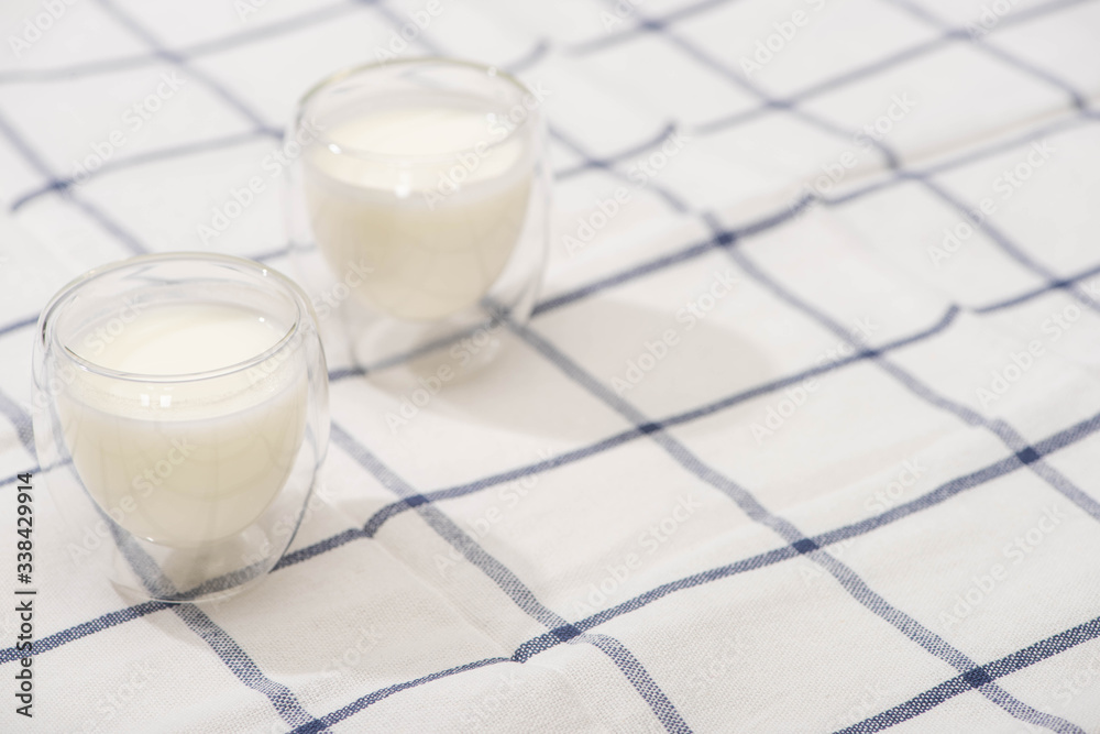 Wall mural high angle view of glasses of homemade yogurt on plaid fabric