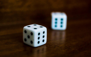 Die/Dice on Backgammon board game - dark mahagoni wood, shadows - casino