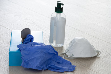 mask, gloves and an antibacterial agent in a plastic bottle