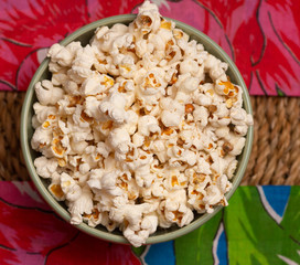 top view of  big bowl  full of popcorn  on the straw table