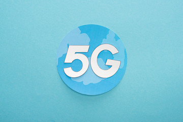 top view of white 5g lettering on globe on blue background