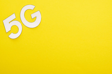 top view of white 5g lettering on yellow background
