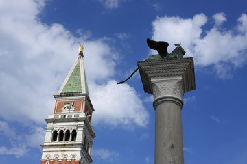 Fototapeta na wymiar St Mark's column in Venice against a blue sky with white clouds