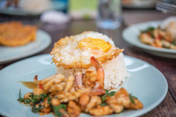 Fried egg on cooked rice.
