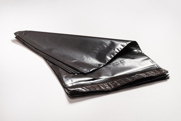 Set of black polythene envelopes on grey background