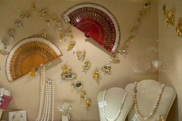 Fans and jewelry displayed in store window of Rome, Italy, Europe